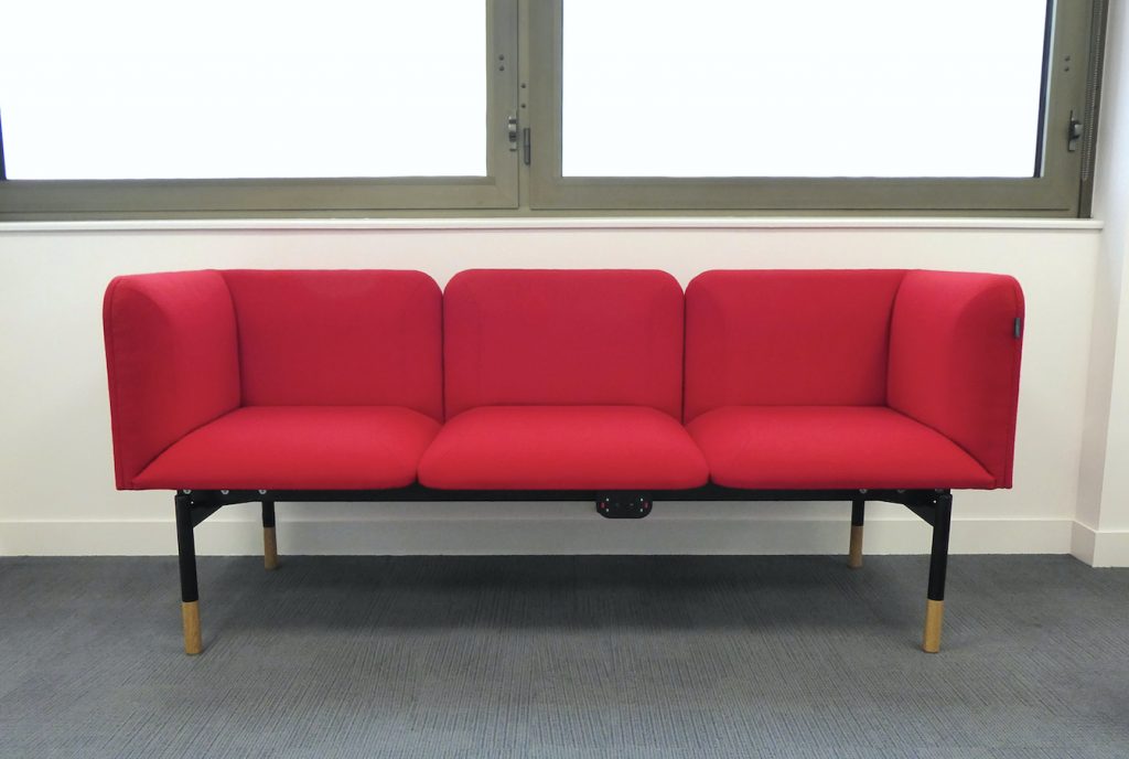 Office breakout space, with sofas upholstered in red fabric